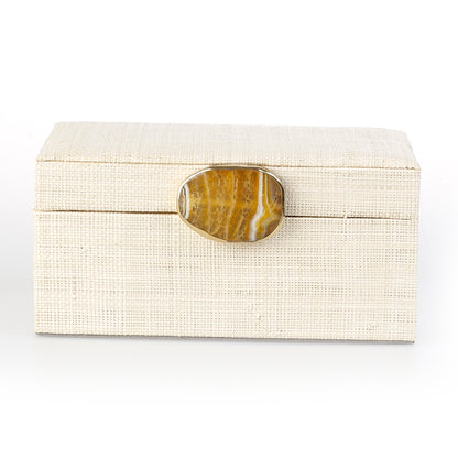 Karuna Raffia Jewelry Box crafted from handwoven natural plant fiber raffia with an agate stone accent capped in hand-tooled brass, perfect for stylish and eco-friendly jewelry storage.