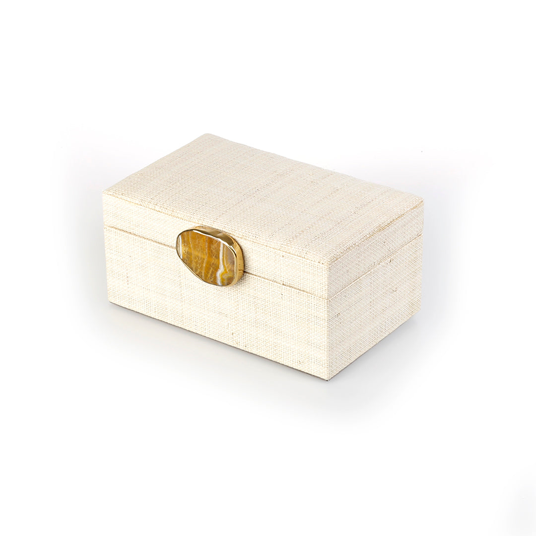 Karuna Raffia Jewelry Box crafted from handwoven natural plant fiber raffia with an agate stone accent capped in hand-tooled brass, perfect for stylish and eco-friendly jewelry storage.