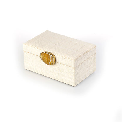Karuna Raffia Jewelry Box crafted from handwoven natural plant fiber raffia with an agate stone accent capped in hand-tooled brass, perfect for stylish and eco-friendly jewelry storage.