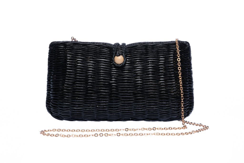 Myra Wicker Clutch Black handwoven from rattan with a brass chain strap and lined with linen and cotton, perfect for both day and night wear.