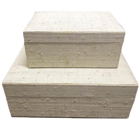 Set of 2 Adie storage boxes with natural plant fiber exterior and faux suede lining, ideal for organizing and adding style to any space.