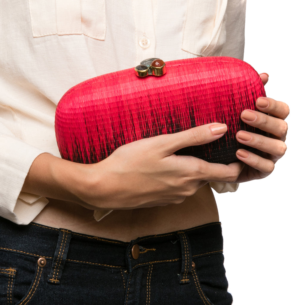 Horizon oval hard case purse handwoven from natural plant fibers, featuring agate stone accents wrapped in brass, a twill lining, and a brass drop-in chain for versatile wear.