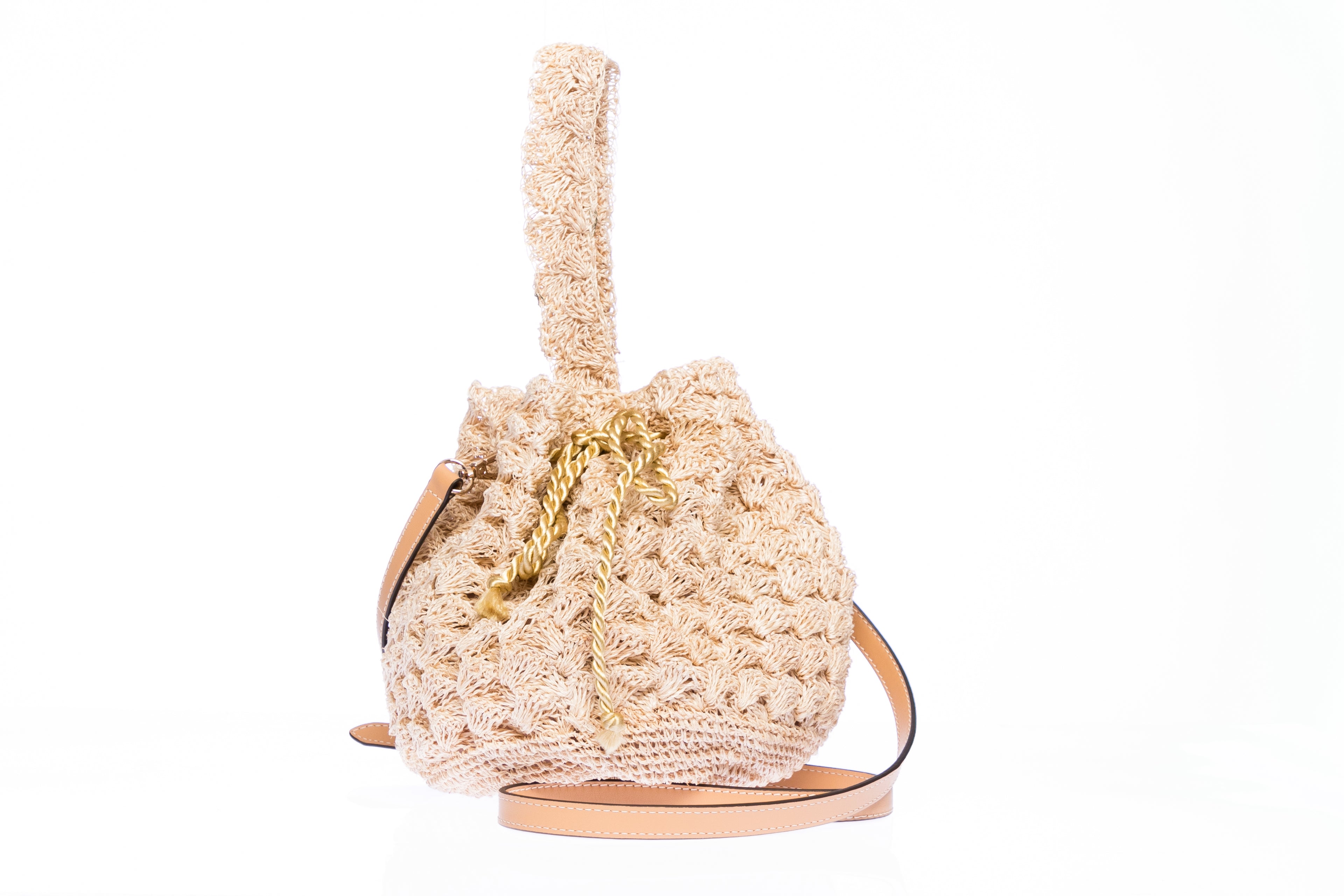 Rie Pouchette wristlet and shoulder bag, handcrafted from sustainable abaca plant fiber with delicate crochet detailing and adjustable leather strap for versatile use.