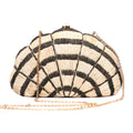 Seashell Karuna Clutch featuring hand-embroidered raffia fiber, freshwater pearls wrapped in brass, and a brass drop-in chain strap for versatility.