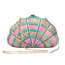 Load image into Gallery viewer, Seashell Karuna Rainbow Clutch, hand-loomed raffia body with hand embroidery, adorned with freshwater pearls wrapped in brass, and a versatile brass drop-in chain strap.
