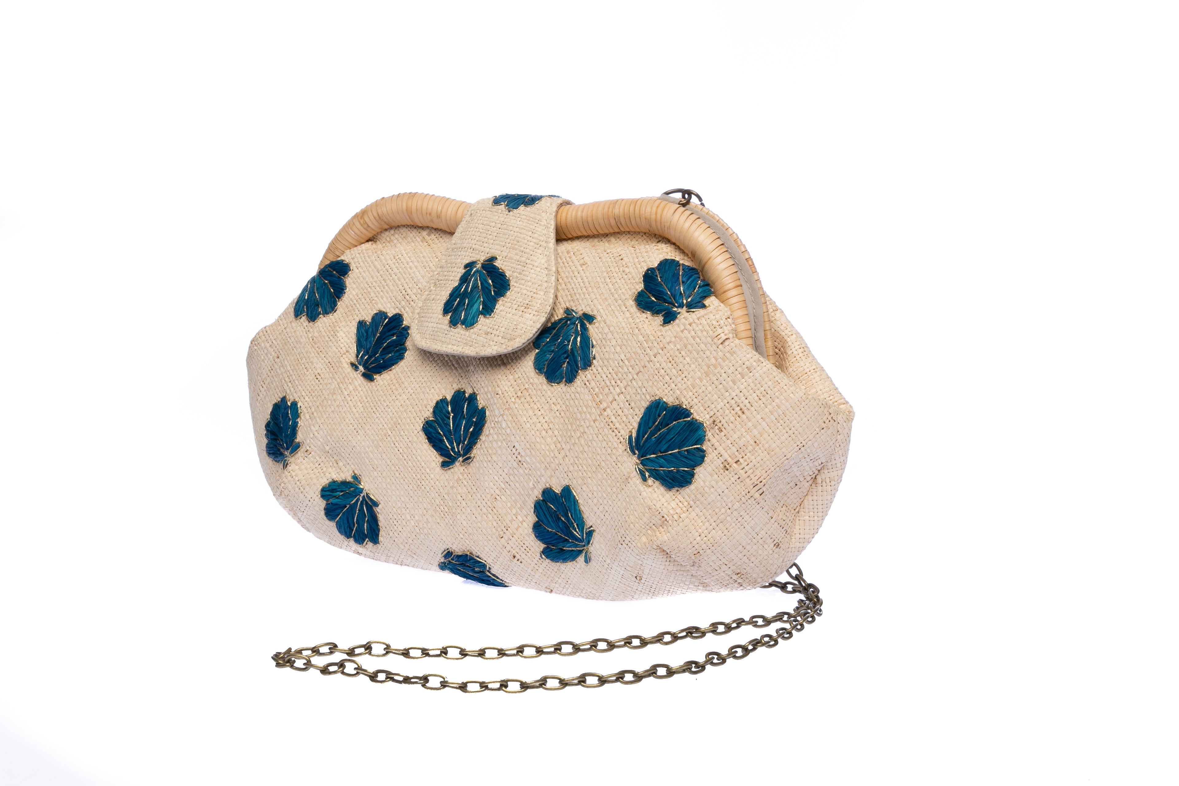 Seashell Signature raffia purse with hand-embroidered chevron design, featuring a removable brass chain for versatile wear as a shoulder bag or clutch.
