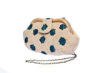 Load image into Gallery viewer, Seashell Signature raffia purse with hand-embroidered chevron design, featuring a removable brass chain for versatile wear as a shoulder bag or clutch.

