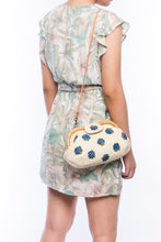 Load image into Gallery viewer, Seashell Signature raffia purse with hand-embroidered chevron design, featuring a removable leather strap for versatile wear as a shoulder bag or clutch.
