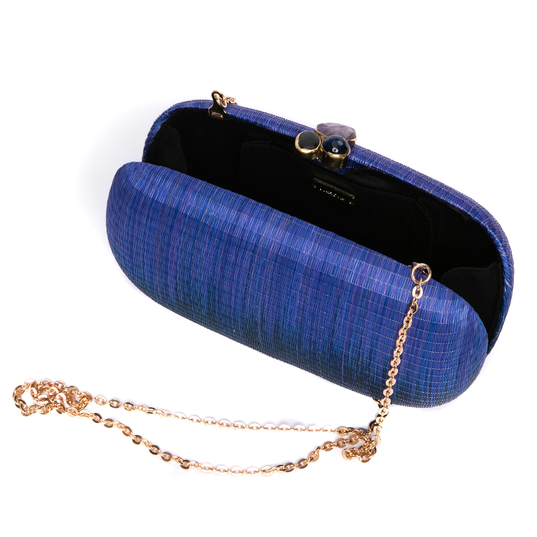 Still Waters Oval Hard Case Purse, handwoven from Buri plant fibers with agate stone accents and a brass chain strap for versatile carrying options.