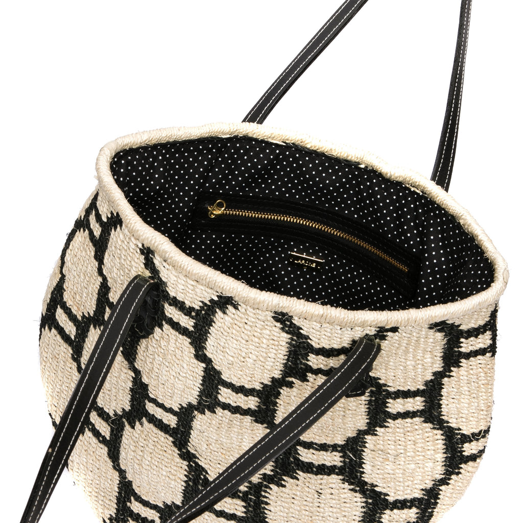Beehive Tote Bag handwoven from natural plant fiber with leather handles and polka dot lining. Stylish and sustainable.