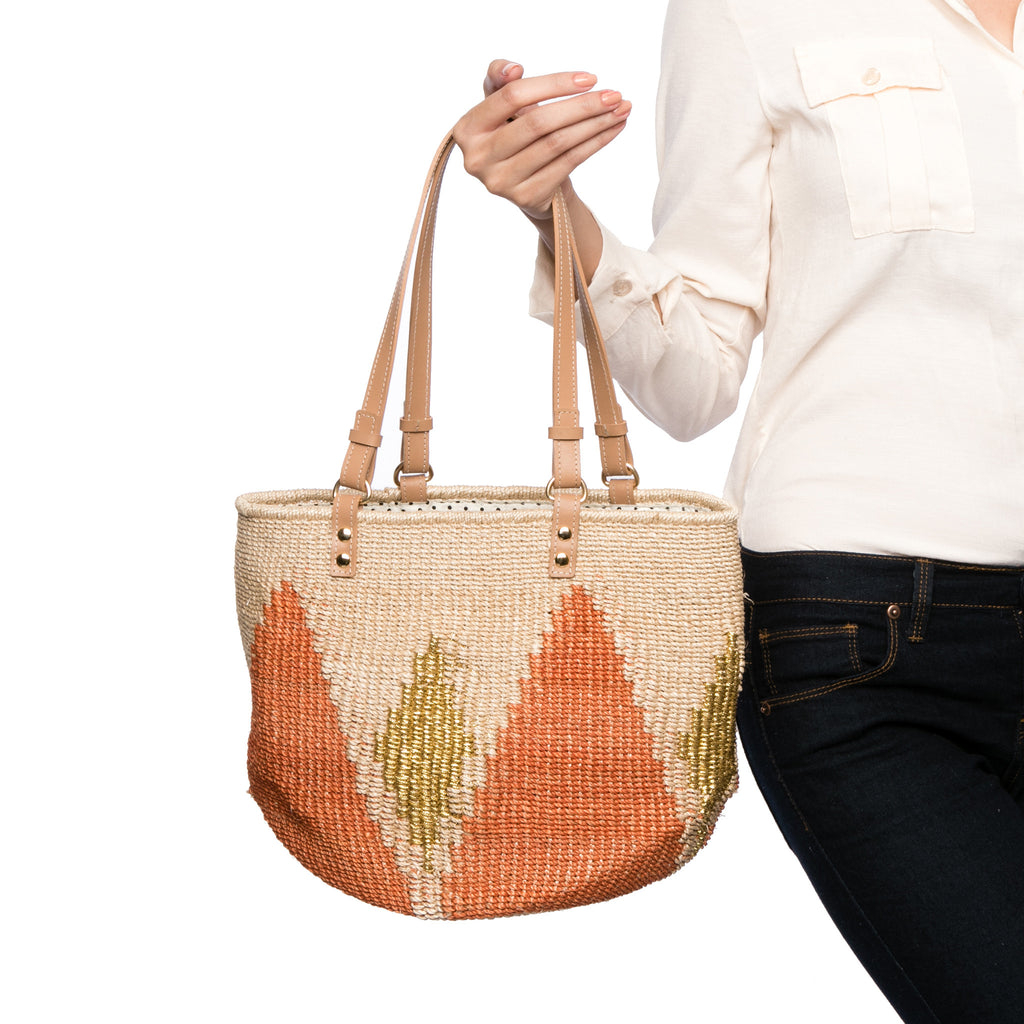 Sunrise Rae Tote, made from natural plant fibers and gold-colored polyester cord, with cow leather handles for durability and style.